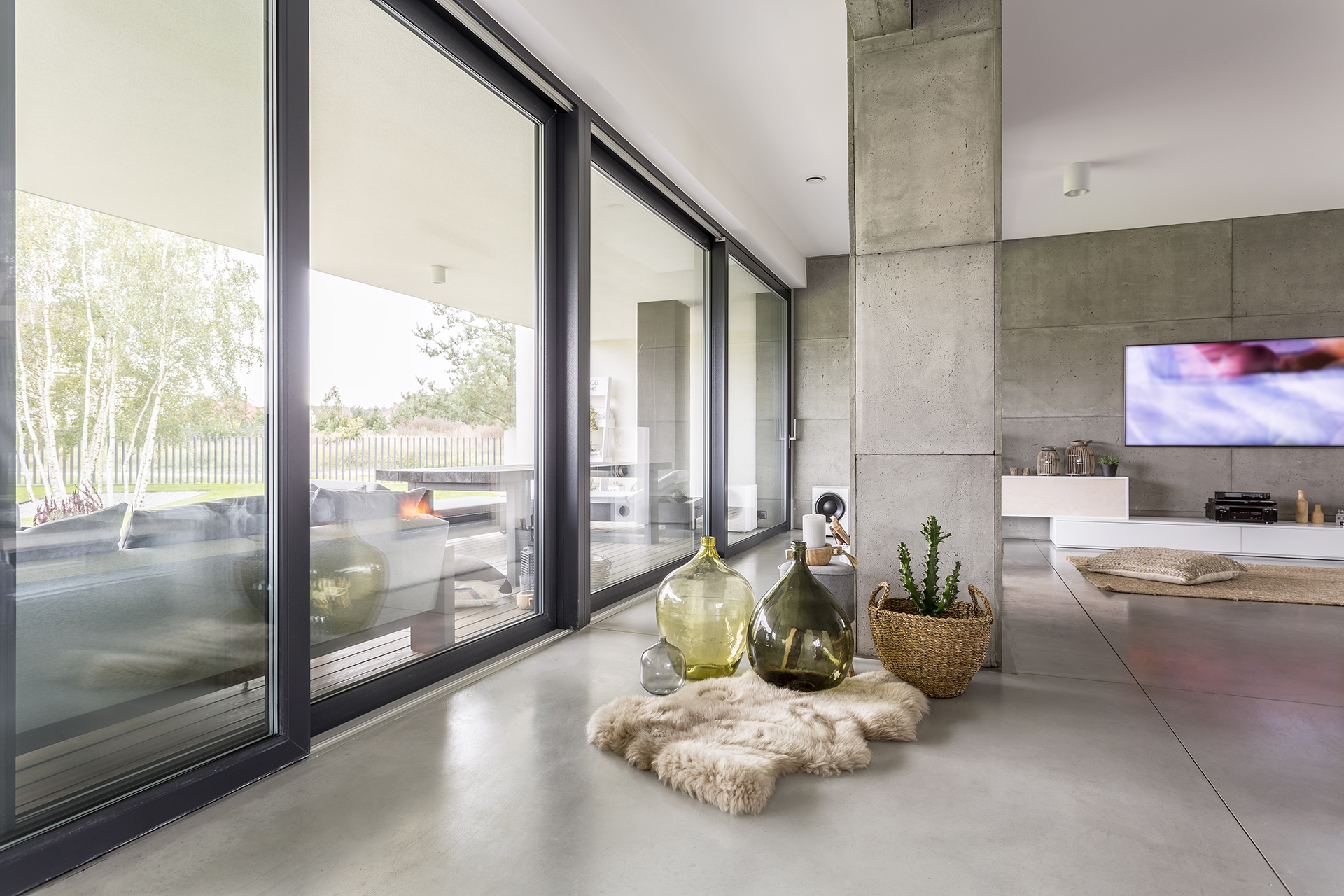 Giant column supporting the house standing next to a windowed wall